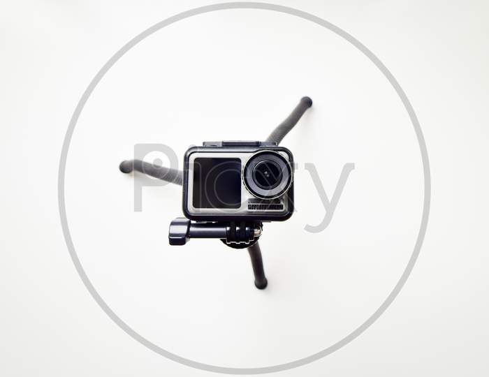 Action Camera Isolated On A White Background With Tripod Looking Up Straight
