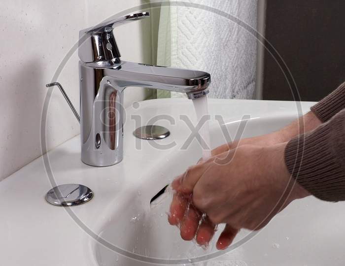 Unrecognisable Person Washing Hands