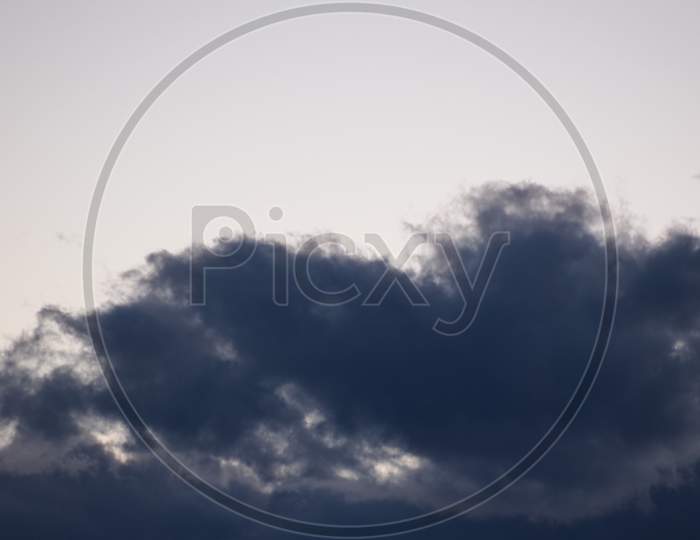 Dark Blue Sky With Clouds Background