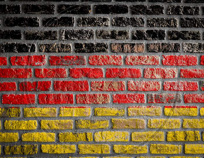 National Flag Of Germany
 Depicting In Paint Colors On An Old Brick Wall. Flag  Banner On Brick Wall Background.