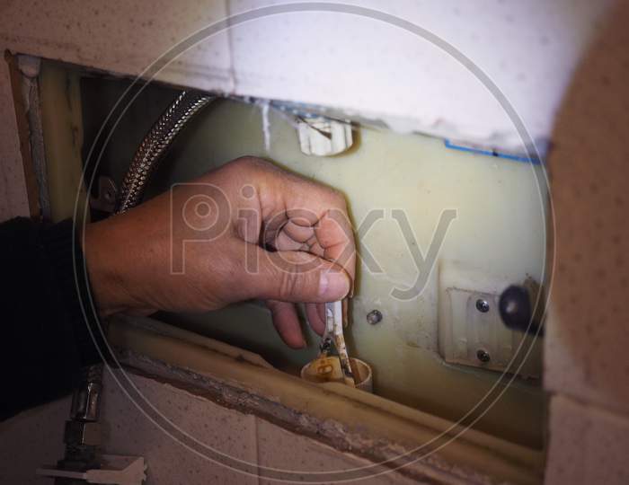 Plumber Repairing Toilet Tank