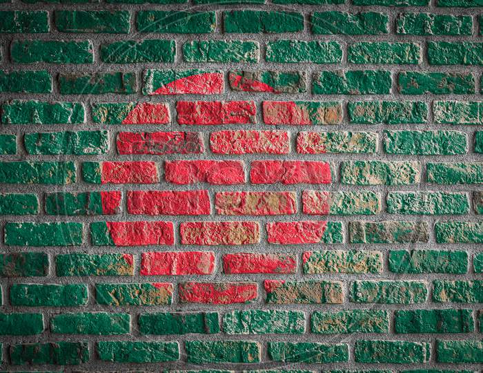National Flag Of Bangladesh
 Depicting In Paint Colors On An Old Brick Wall. Flag  Banner On Brick Wall Background.