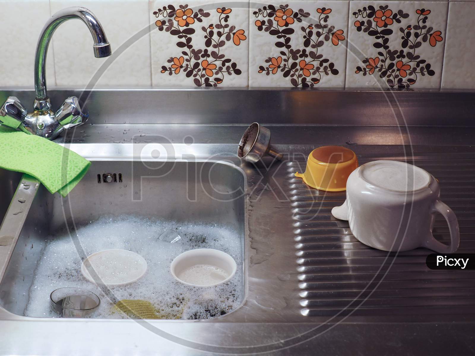 Hand Dish Washing In Kitchen Sink With Detergent Foam