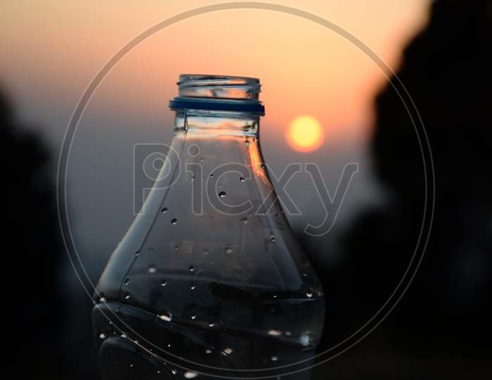 Picture Of A Water Bottle And Sunset In Background, Background Blur
