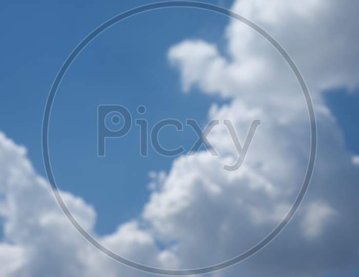 Blurred Out Of Focus Blue Sky With Clouds Background