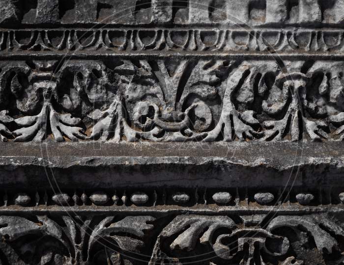 Close-Up Pattern On Antique Stone Column.Elements Of Ancient Greek Architecture  . Detail Of The Facade Of The City Building