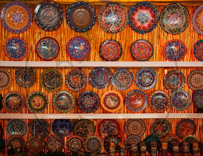 Classical Turkish Ceramics On The Istanbul Grand Bazaar. Colorful Ceramic Plates For Sale In Turkey. Decorated Tableware In The Tourist Store. Souvenir Shop