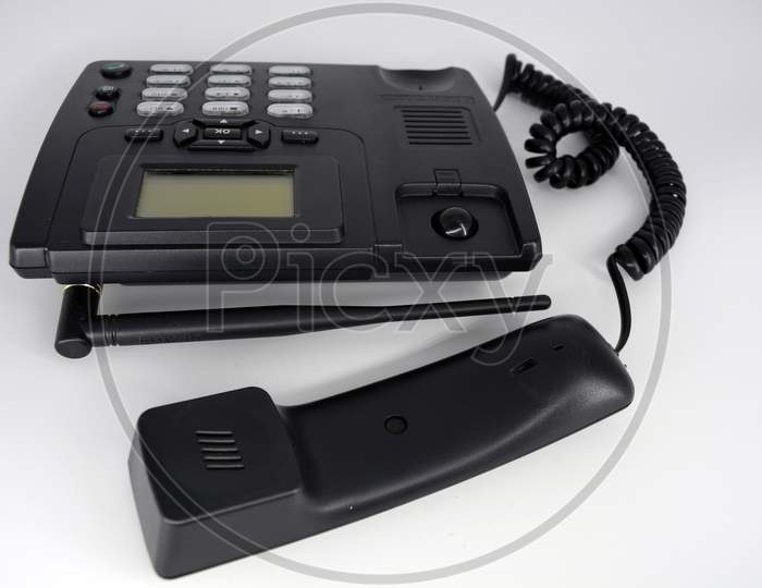 Stationary black plastic radio telephone, telephone with screen, tube and screwed cord.