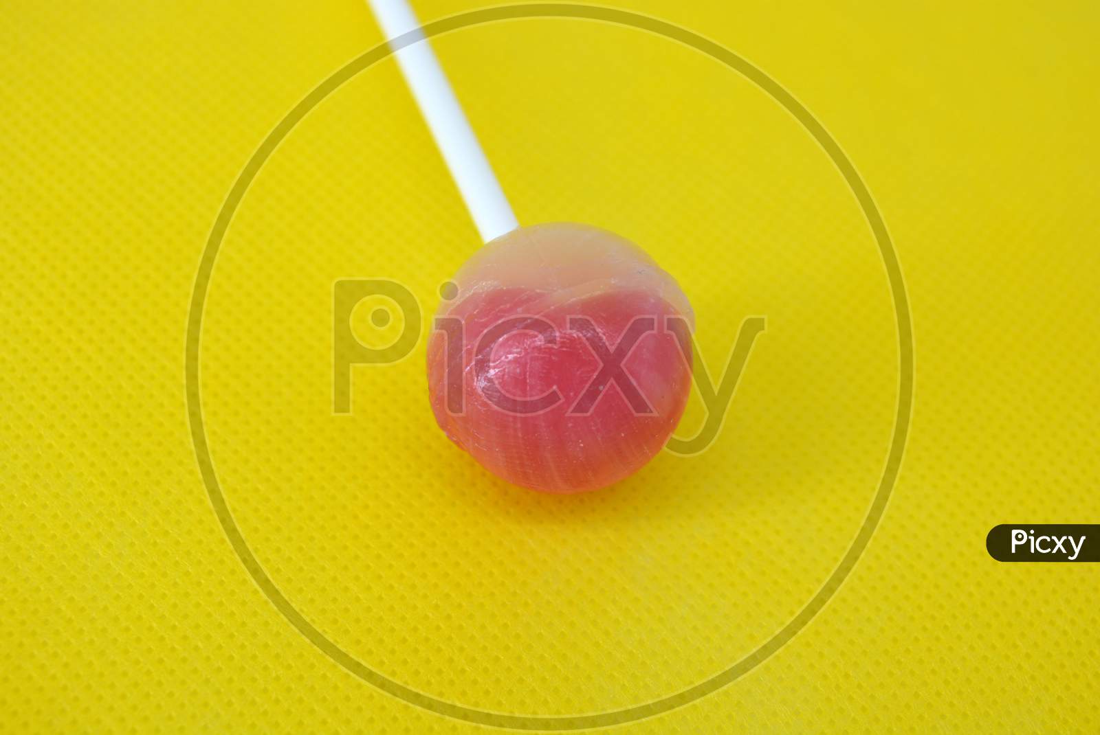 image-of-delicious-round-sweet-candy-white-pink-lollipop-on-white