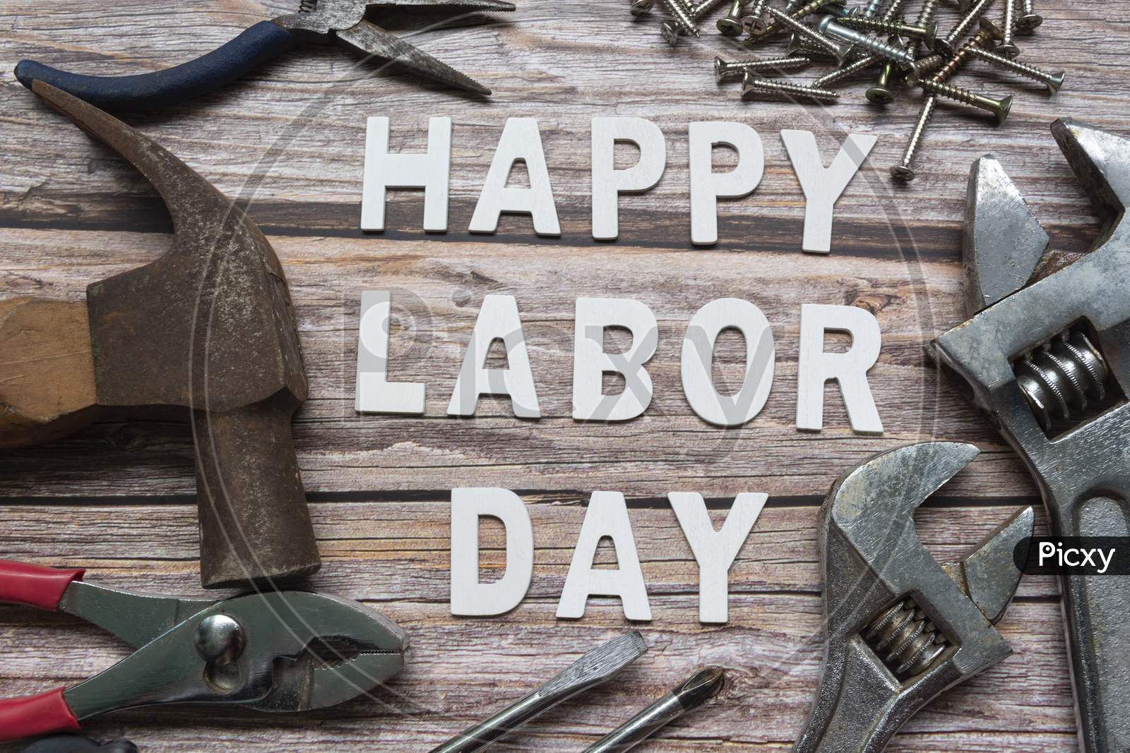 Happy Labor Day Text With Many Handy Tools On Wooden Background