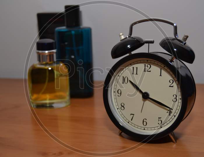 Perfume And An Antique Alarm Clock