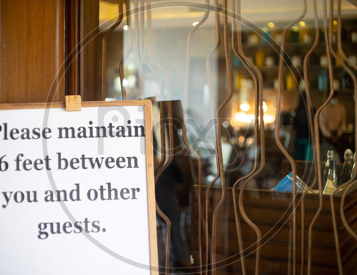 Social Distancing Sign Please Maintain 6 Feet Between You And Other Guests At A Restaurant Pub, Resort Hotel Spa As Businesses Open Up Gradually During The Covid19 Coronavirus Pandemic