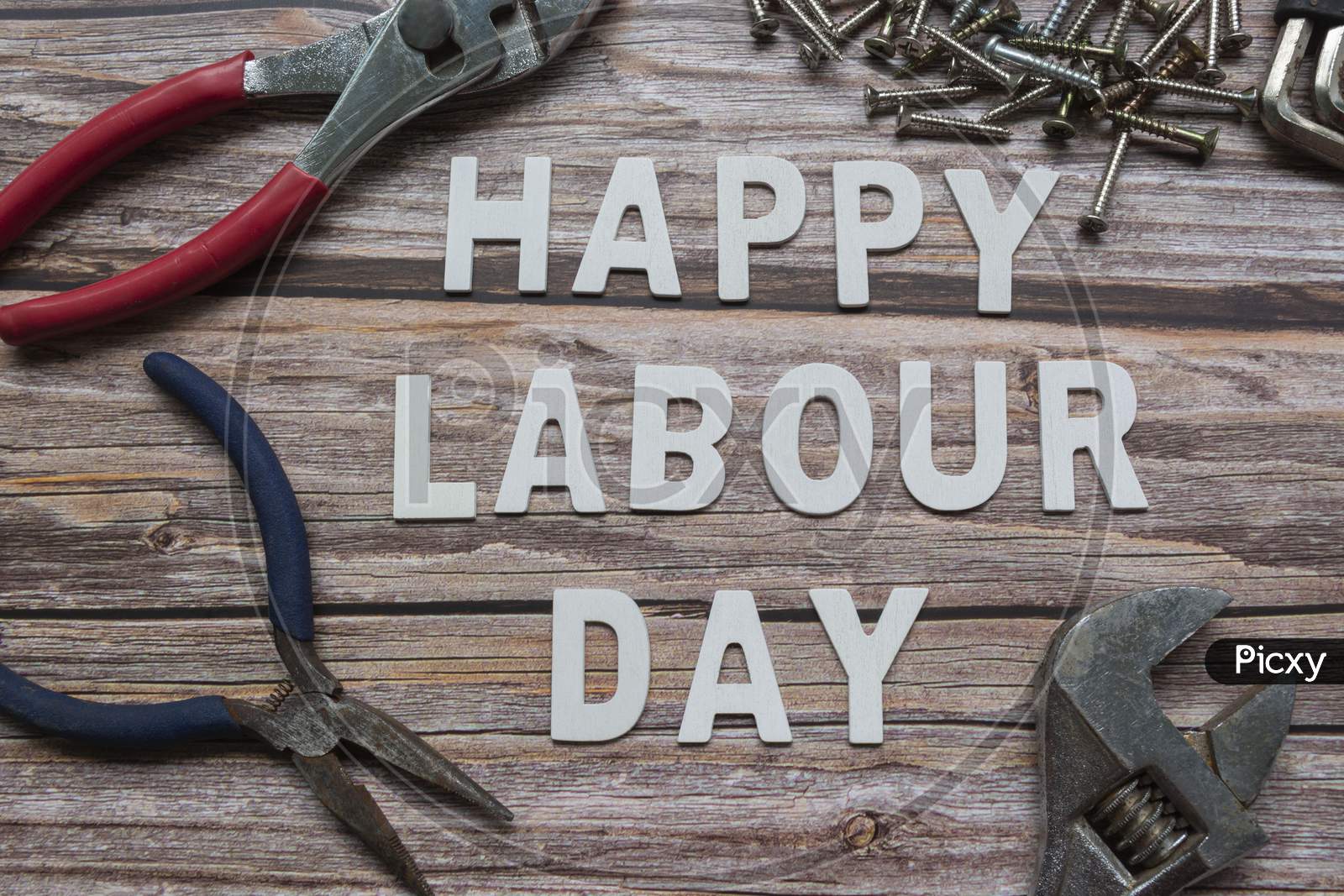 Happy Labor Day Text With Many Handy Tools On Wooden Background