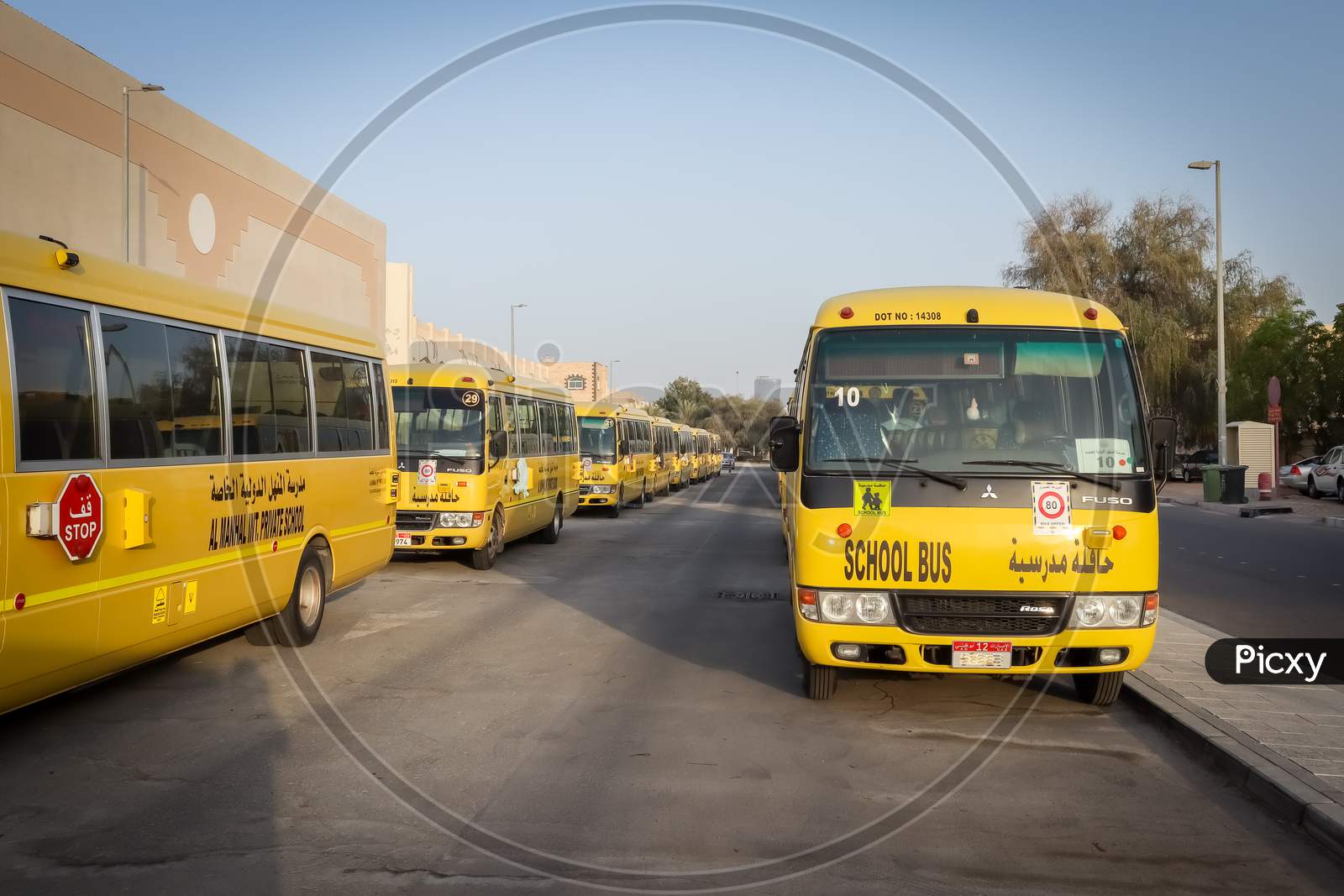 United Arab Emirates - 3 April 2021, Yellow Arabic School Bus Lined Up And Parked Outside The School Bus Parking At Abu Dhabi