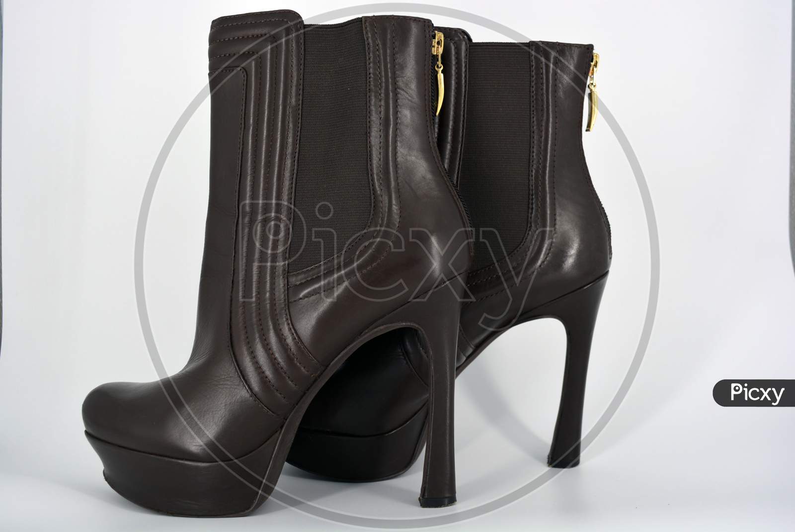 Brown sexy stylish female autumn boots with a wide gum from a natural smooth. Women's shoes on a high thin hairpin, a wide platform with a zipper on the heel located on a white background.