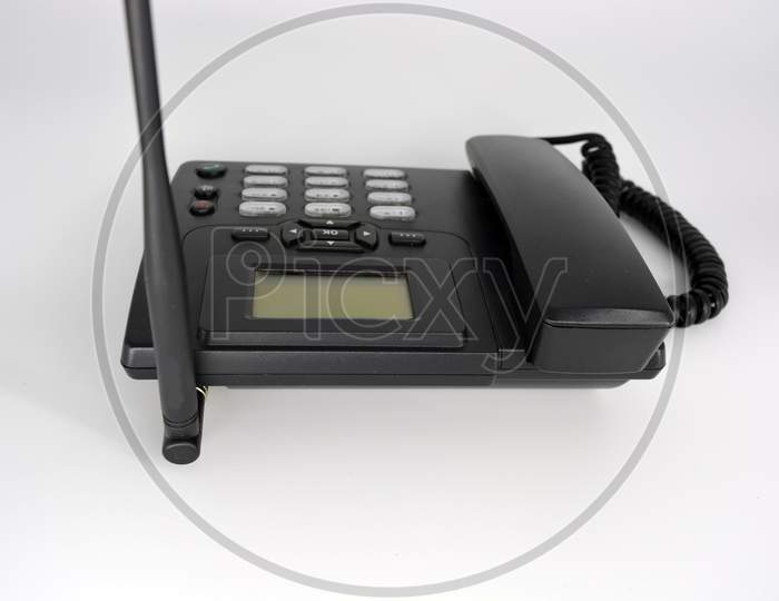 Stationary black plastic radio telephone, telephone with screen, tube and screwed cord.