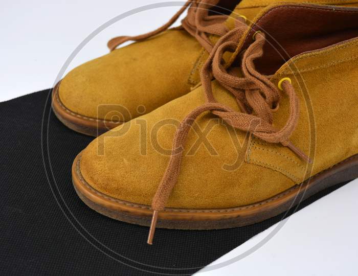 Casual, universal ordinary shoes for a daily walk. Brown half boots, shoes on a wide beige cachic sole. Footwear made of genuine leather, natural suede with brown wide shoelaces.