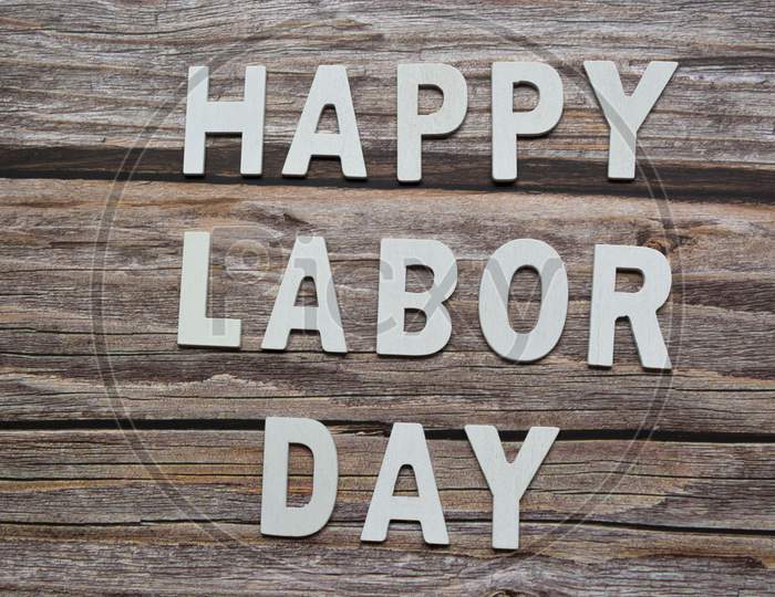 Happy Labor Day Text On Wooden Table Background. Labor Day Concept