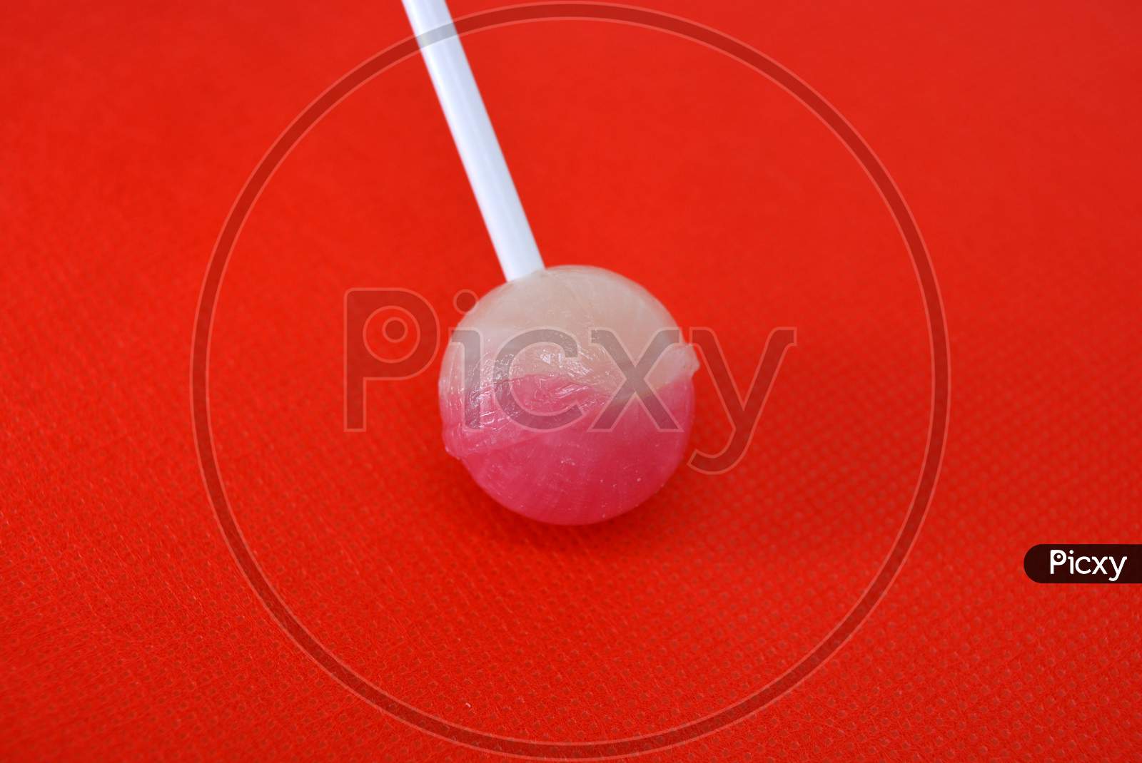 image-of-delicious-round-sweet-candy-white-pink-lollipop-on-white