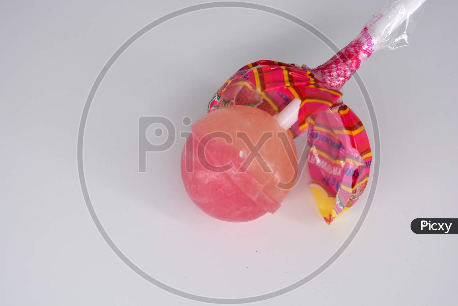 image-of-delicious-round-sweet-candy-white-pink-lollipop-on-white