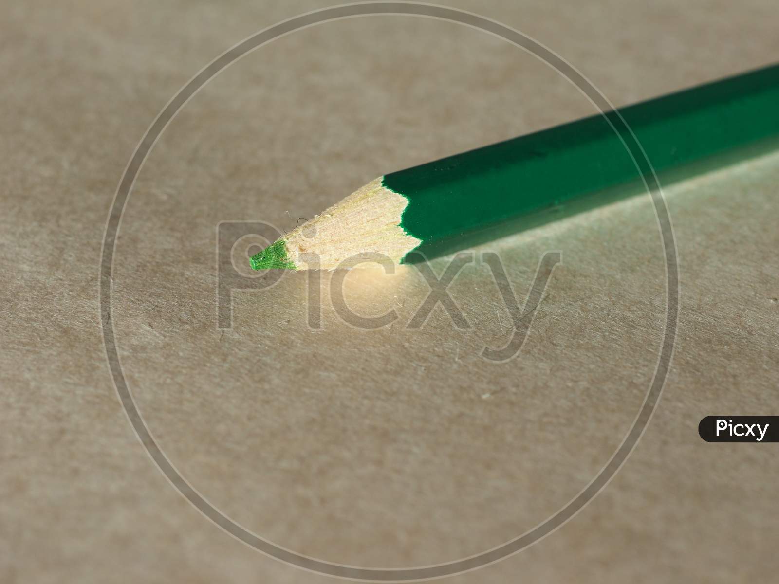 Green Pencil Over Paper