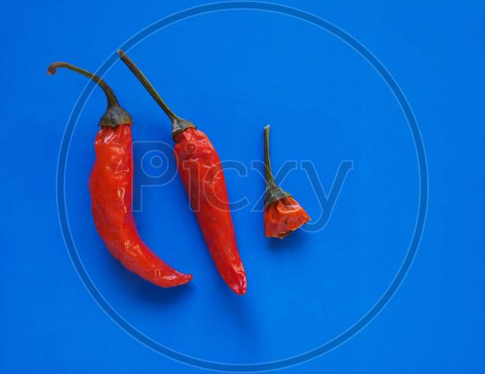 Hot Chili Pepper Vegetables Over Blue With Copy Space
