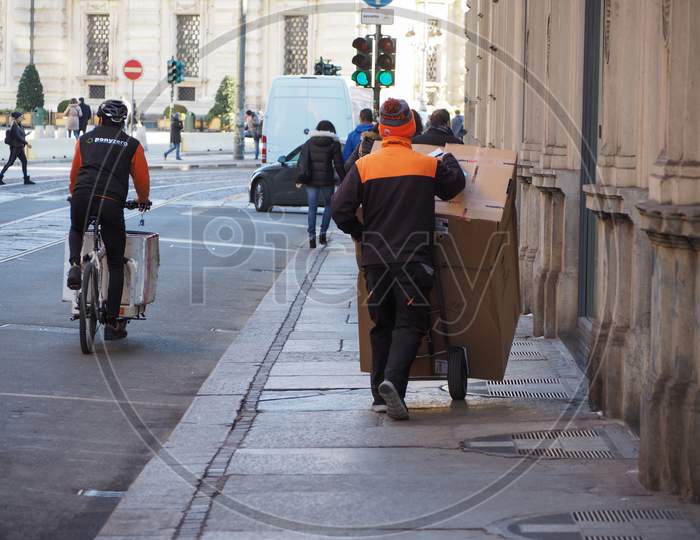 Turin, Italy - Circa January 2018: Parcel Delivery Courier In City Centre
