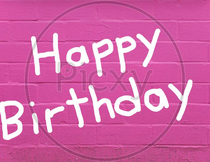 Happy Birthday Over Pink Brick Wall