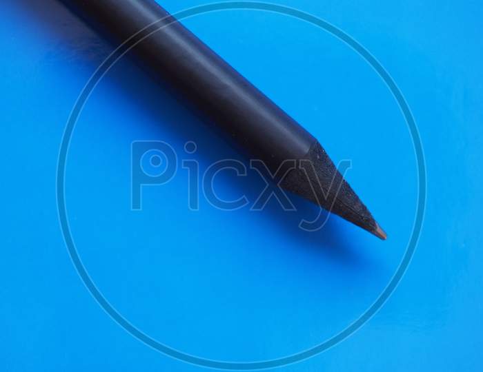 Black Pencil Over Blue With Copy Space