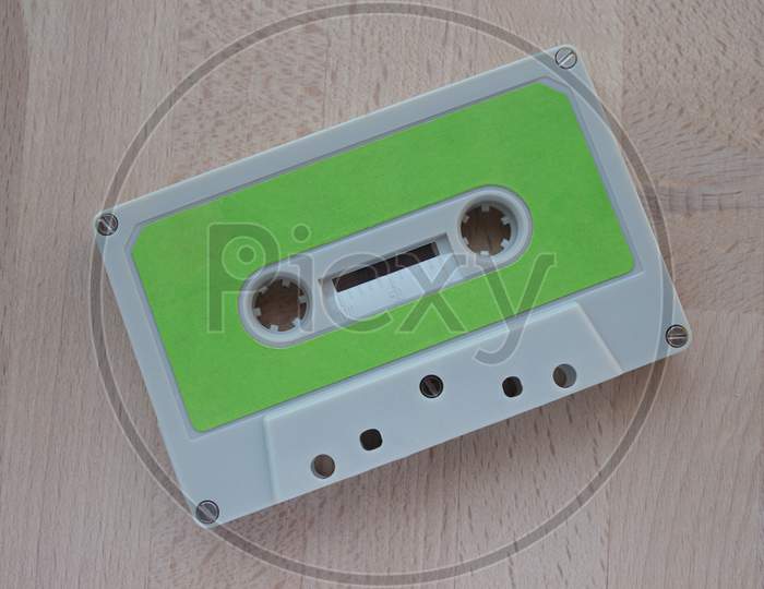 Tape Cassette On Wooden Desktop