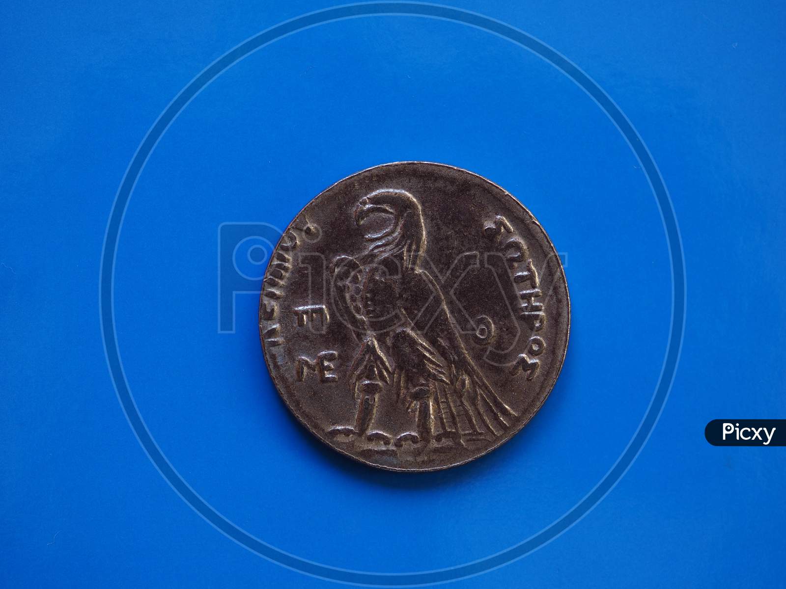 Ancient Greek Coin Over Blue