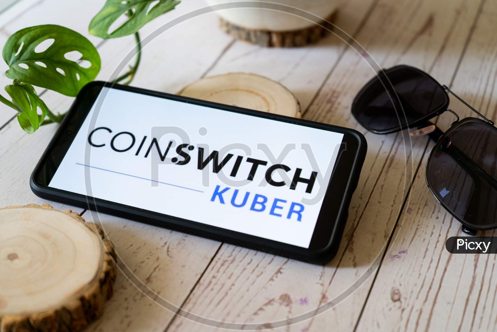 Indian Startup Blockchain Bitcoin Altcoin App Coinswitch Kuber On A Mobile Phone On A Wooden Table Showing This Easy Legal Way To Trade Etherium And Dogecoin In India