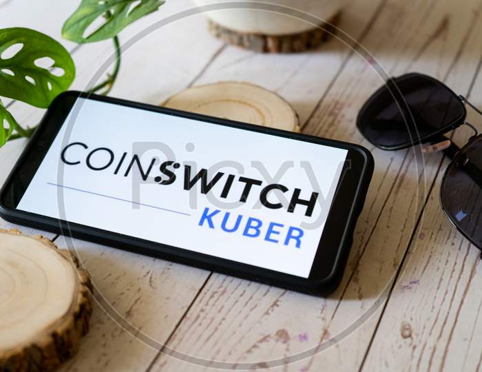 Indian Startup Blockchain Bitcoin Altcoin App Coinswitch Kuber On A Mobile Phone On A Wooden Table Showing This Easy Legal Way To Trade Etherium And Dogecoin In India