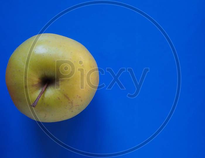 Green Apple Fruit Food Over Blue With Copy Space
