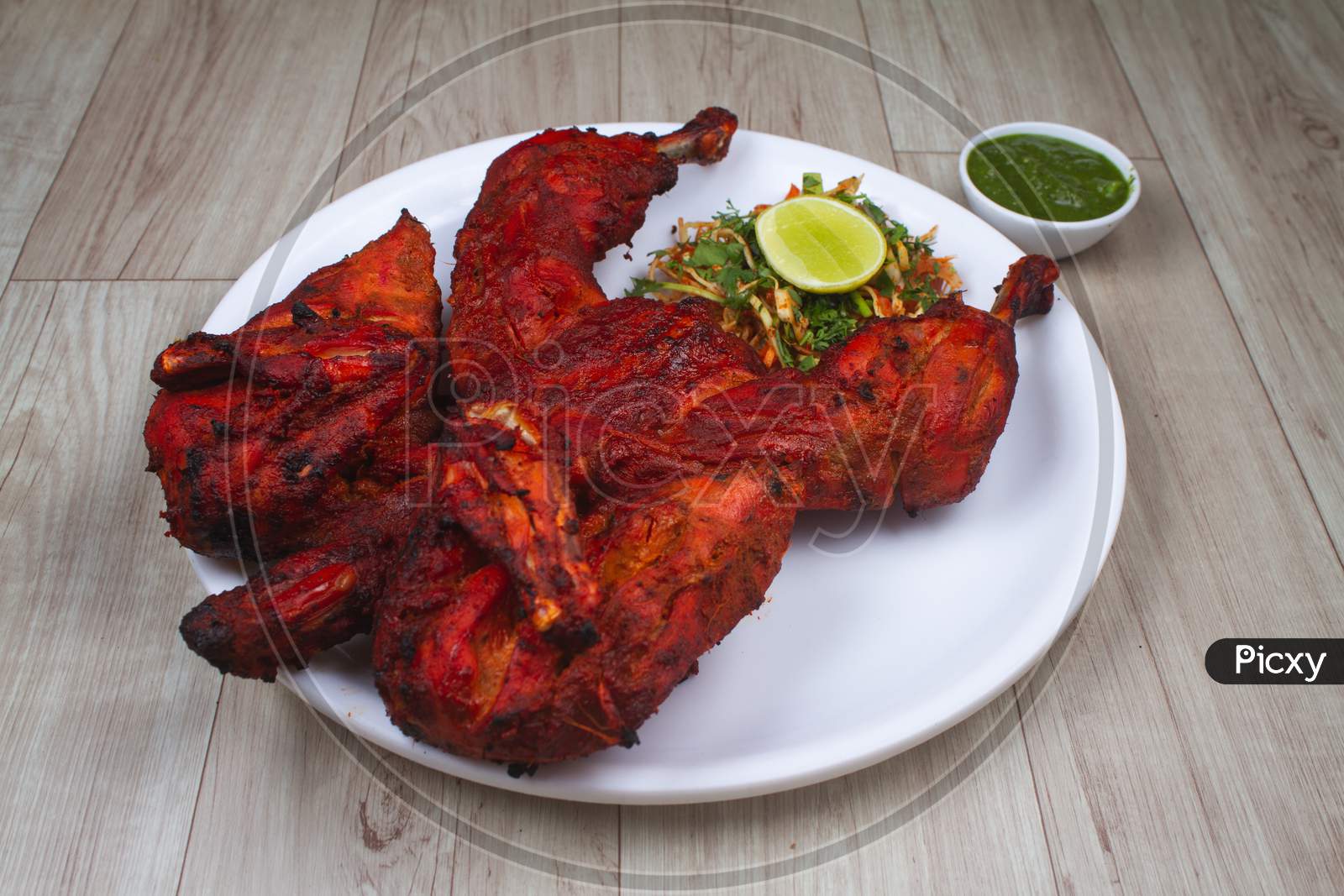 Tandoori Chicken Is Chicken Dish Prepared By Roasting Chicken Marinated In Yoghurt And Spices In A Tandoor, A Cylindrical Clay Oven. It Is A Popular Dish From The Indian.