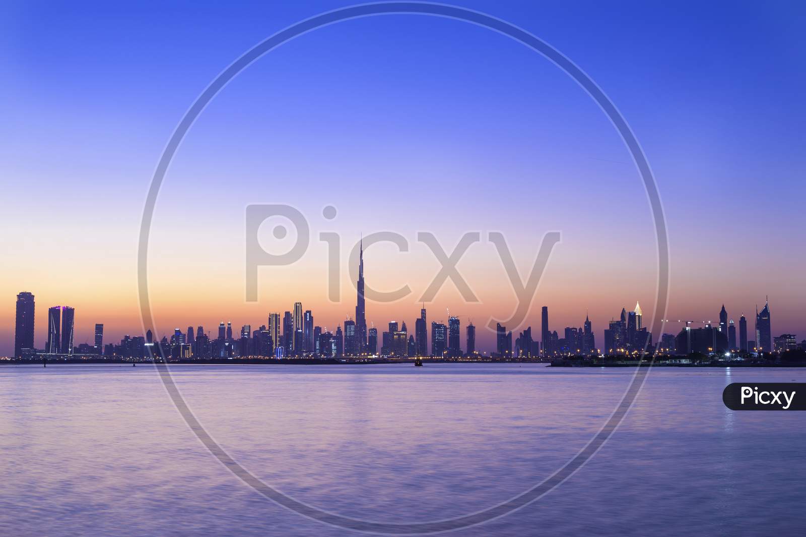 1St Dec 2020. Panoramic View Of The Dubai Skyline With Burj Khalifa And Other Sky Scrapers Captured At The Sunset With The Beautiful Blue Sky At The Dubai Creek, Ras Al Khor, Uae.