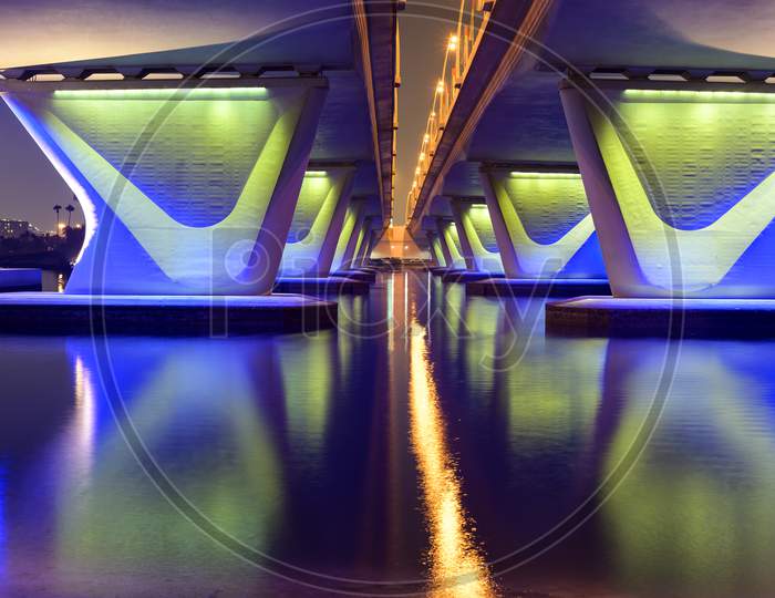 5Th November 2020 Dubai Uae. Beautiful Winter Night View Of The Famous Blue Illuminated Al Gharhoud Bridge In Dubai, United Arab Emirates With The Colorful Reflection On The Water.