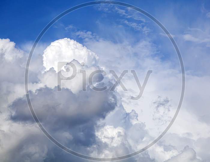 Stunningly Blue Sky With Lots Of Clouds Of Different White And Gray On A Bright Sunny Day. Great Texture Of Clouds And Summer Sky