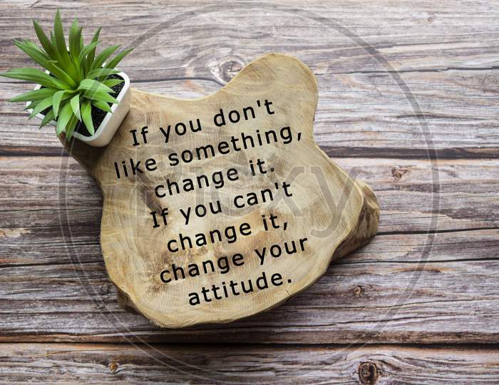 Motivational Quote Written On Wooden Board With Potted Plant On Wooden Background