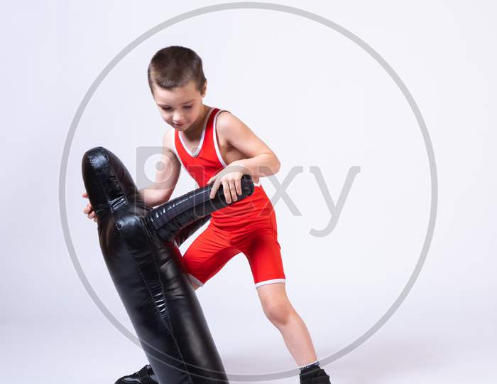 Cheerful Sport Boy In Wrestling Tights And Wrestlers Makes A Throw Through The Back With A Sporting Dummy For Training And Handling Techniques From Various Martial Arts On A Spruce Isolated Background