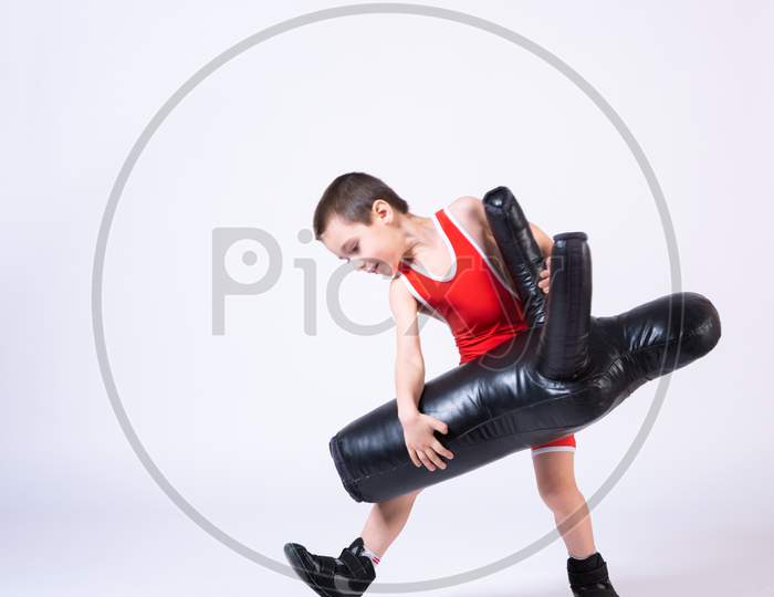 Cheerful Sport Boy In Wrestling Tights And Wrestlers Makes A Throw Through The Back With A Sporting Dummy For Training And Handling Techniques From Various Martial Arts On A Spruce Isolated Background