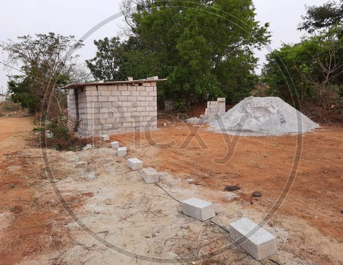 Closeup of construction of new building with cement block and m sand or artificial sand at empty field of rural area.