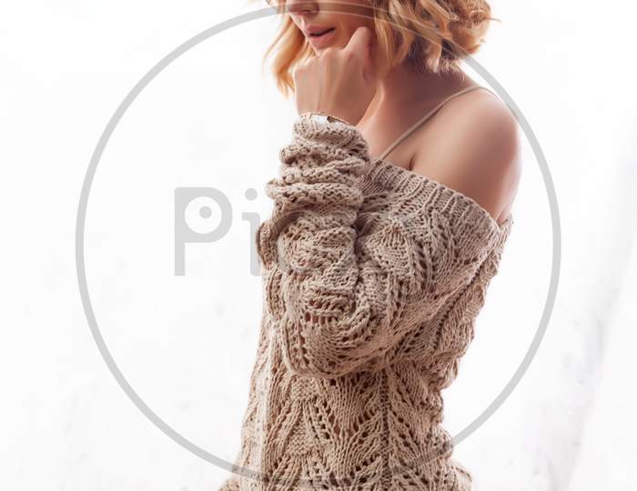 Fashion Lifestyle Portrait Of Young Trendy Woman Dressed In Brown Knit Sweater Made Of Natural Wool  Laughing, Smiling, Posing  On Isolated Background.Portrait Of Joyful Woman