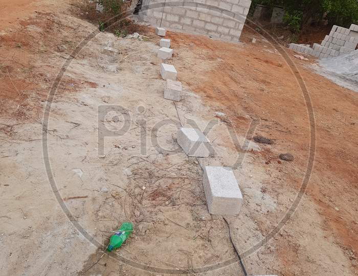 Closeup of construction of new building with cement block and m sand or artificial sand at empty field of rural area.