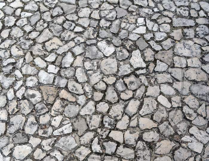 Detailed Close Up On Old Vintage Cobblestone Roads And Walkways Placed On A Floor Inside Of Wawel Castle In Krakow, Poland, Europe. Abstract Stone Rock Pattern Texture Background