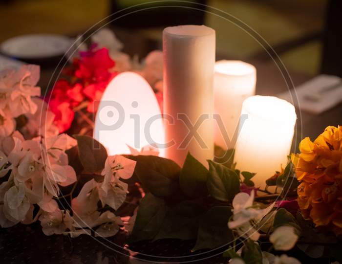 Slow Wide Angle Shot With Flowers And Candles And A Flickering Dome Light Showing The Setting For A Romantic Lunch Dinner Date Or An Event Like A Wedding Or A Celebration