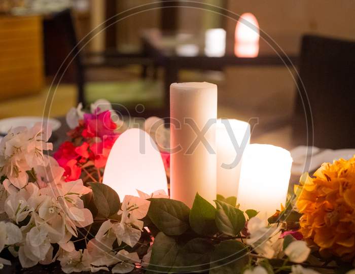 Slow Wide Angle Shot With Flowers And Candles And A Flickering Dome Light Showing The Setting For A Romantic Lunch Dinner Date Or An Event Like A Wedding Or A Celebration