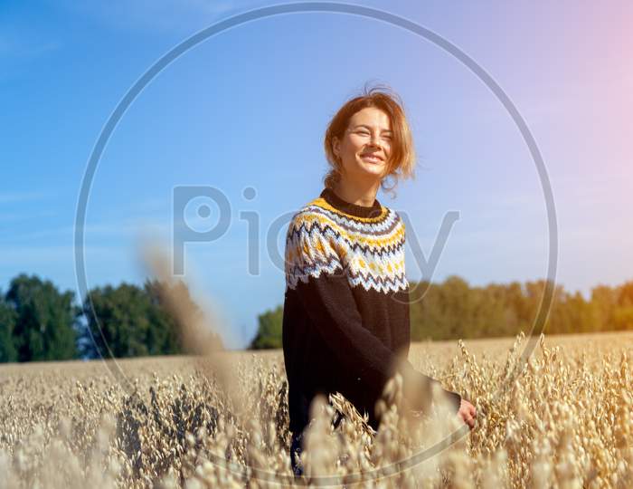 Outdoor Close Up Portrait Of Young Beautiful Woman In Brown Knit Sweater Made Of Natural Wool  Posing On Field In Autumn Park.  Autumn Walking Concept.