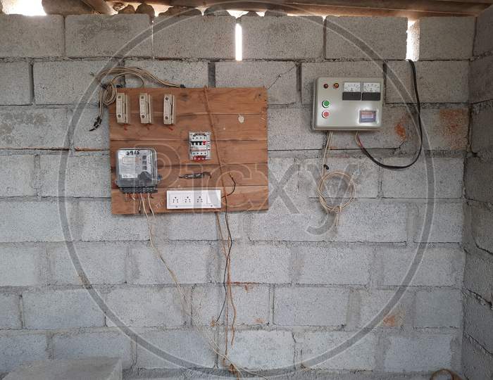 Closeup of new building electricity new connection through switch board and wire by electrician.