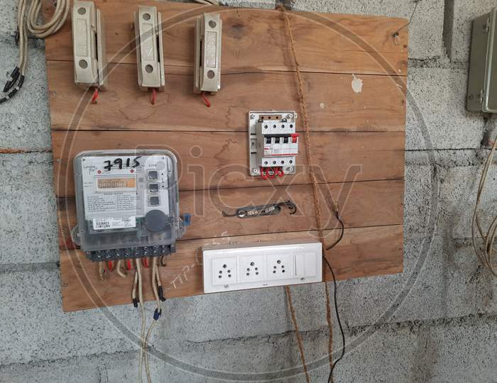 Closeup of new building electricity new connection through switch board and wire by electrician.
